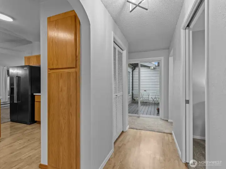 As you enter, warm laminate flooring greets you in the bright and airy foyer.