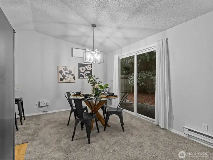 Nearby the kitchen is the dining area with access to the back patio.