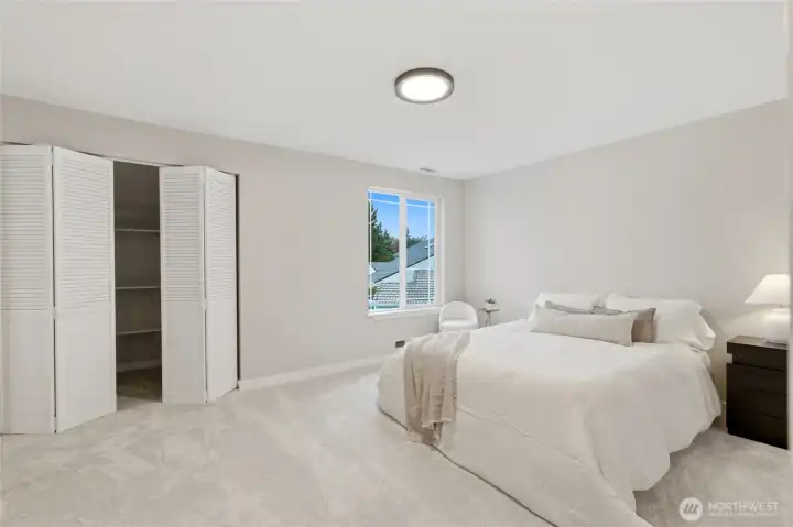 Spacious primary bedroom with natural light