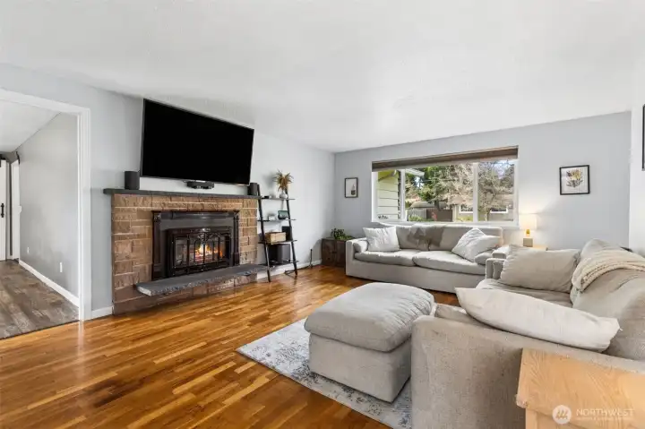Lovely hardwood flooring, gas fireplace, makes this living room super cozy!