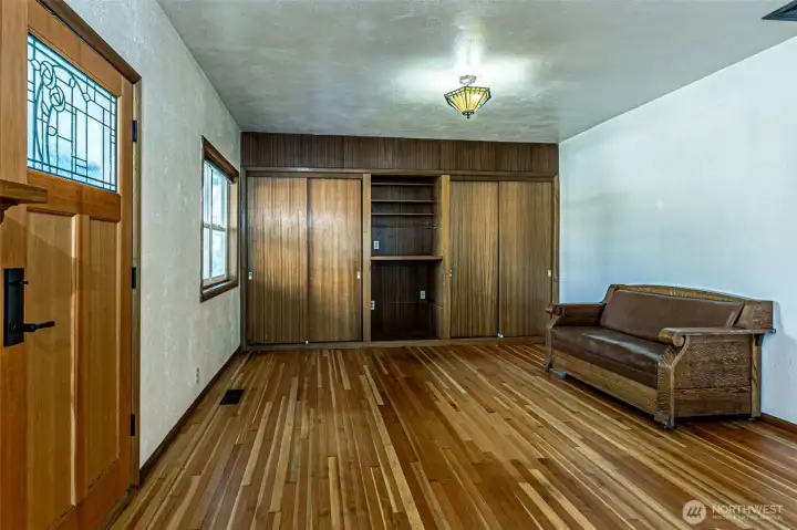 Large Living room with closets and built in entertainment center.