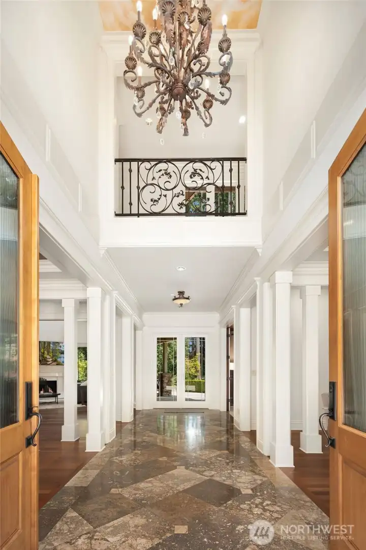 Dramatic Entry w/ travertine floor and   rich hardwood flooring