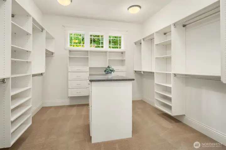 Primary closet is huge and has dedicated space for stack washer/dryer