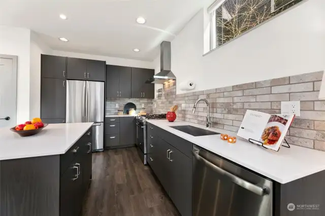 Calling all chefs (and takeout enthusiasts): this sleek kitchen with modern finishes, stainless steel appliances, and a generous island is ready for whatever you’re cooking up.