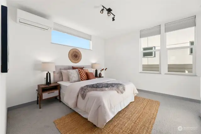 Bathed in natural light from its western and southern exposure, the primary bedroom offers a warm and inviting retreat.