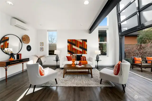 Soaring ceilings and a modern industrial vibe set the stage for this airy living room. Did we mention that garage-style door opens to your private patio? Indoor-outdoor living goals: unlocked.