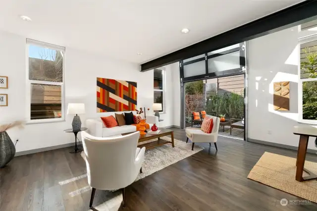 Can’t you just picture a quiet morning here with coffee? That garage-style door transforms this living room into an al fresco paradise—perfect for those crisp Seattle mornings.