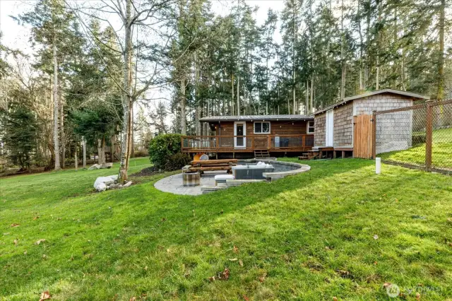 Looking at the cabin, patio and storage shed from the North
