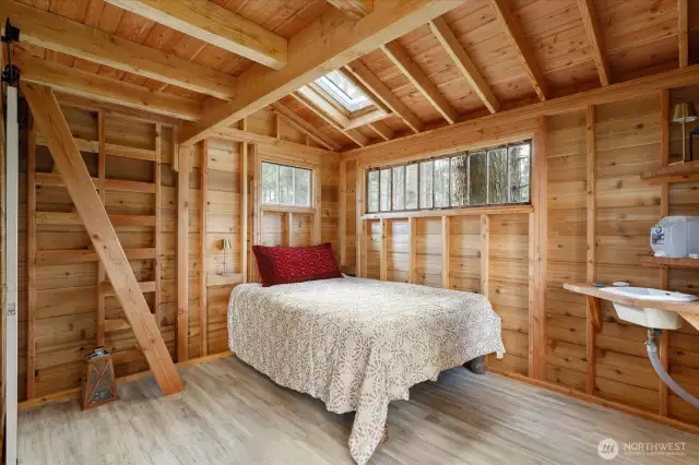 Main level of the treehouse. There is no electricity or running water, but you can use bottled water & sink drains to the septic system.