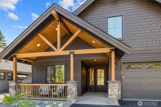 Covered front porch, beautiful stone work and 2 car garage.