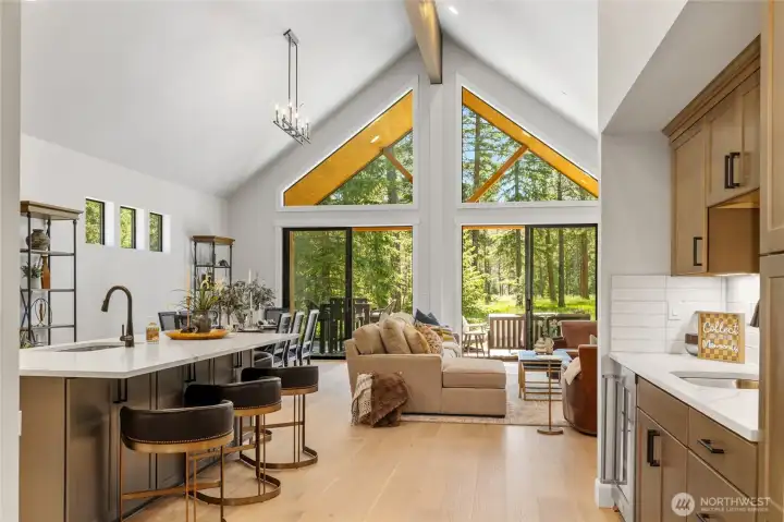 Plenty of light with soaring ceilings in great room, kitchen and dining. Plenty of light with soaring ceilings in great room, kitchen and dining.