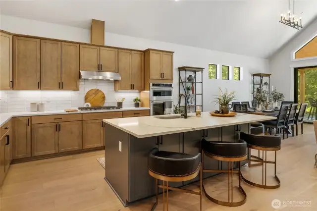 Gourmet kitchen with gas cooktop and stainless steel extraction hood.
