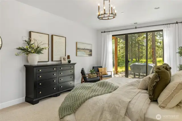 Primary bedroom with sliding glass to outdoor patio.