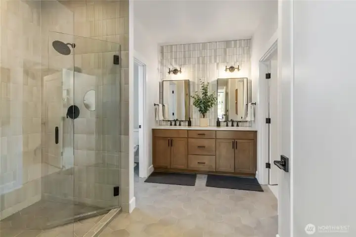 Primary bath walk in shower and double vanity. Primary bath walk in shower and double vanity.