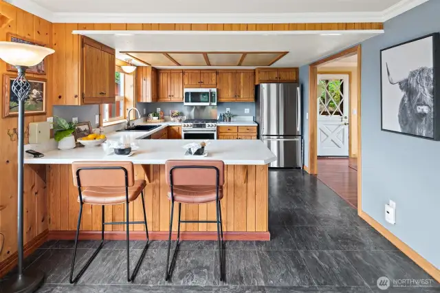 Custom Knotty Pine cabinets, Corian® Counters, Stainless Appliances and Breakfast Bar.