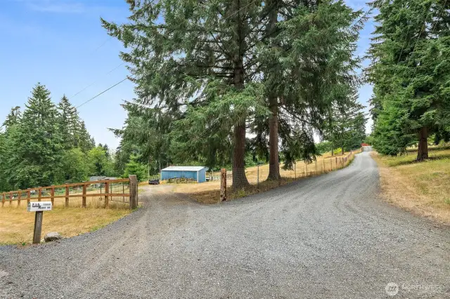 Road access to Barn and Pastures. Private Drive to House and Shop to the right.