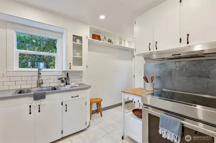 Kitchen includes newer induction range, vented hood and recessed lighting.  Take the stairs to lower level and door to the backyard.