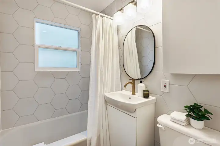 Refinished bathroom on the main level includes beautiful tile work and a heated towel rack for dry, warm towels year-round.