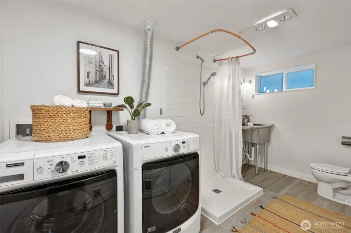 Beautifully refinished lower bathroom with laundry.