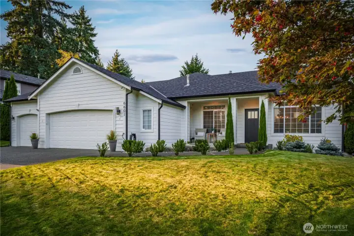 Meticulously curated landscaping makes a stunning first impression.