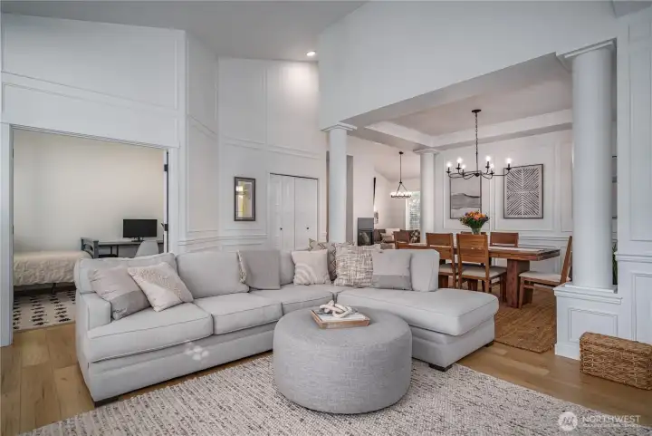 The formal living room flows seamlessly into the elegant dining room.