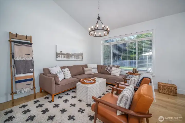 From the dining room, step into the cozy family room with vaulted ceilings and backyard views.