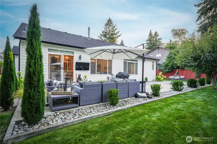 Professionally designed landscaping creates a refined backyard retreat.