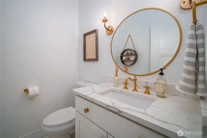 Even the powder room is elevated with quartz countertops and bronze fixtures.