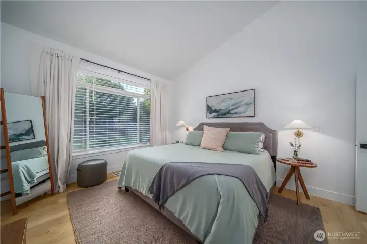 The primary suite is an oasis with vaulted ceilings and abundant light.