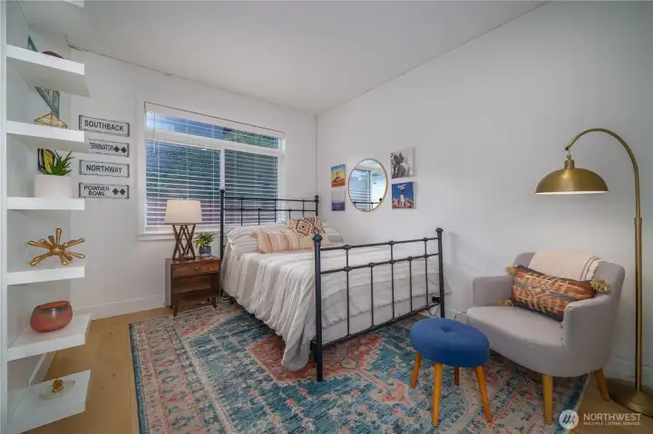 One of three additional bedrooms with a large window and oversized closet.