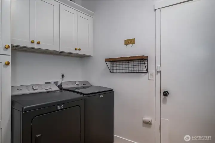 The laundry room boasts extra storage and access to the oversized 3-car garage.