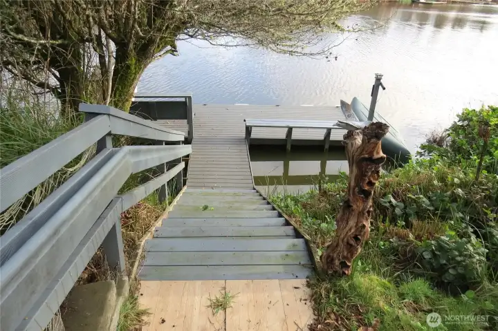 LOOKING DOWN THE STi\AIRWAY TO THE DOCK, THERE IS A CANOE ON THE RIGHT THAT STAYS WITH THE PURCHASE ALSO! AND NOT SHOWN IS A BOAT ON THE LEFT THAT ALSO STAYS!