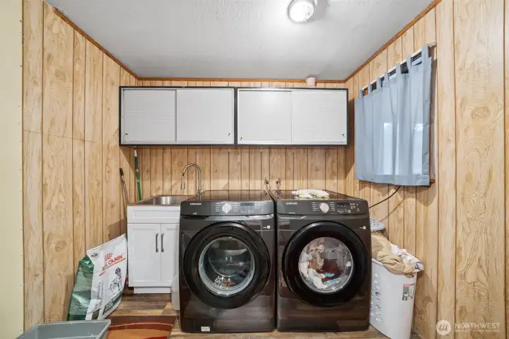Main level laundry room with sliding barn doors for entry