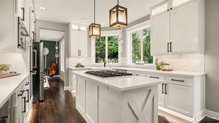 Quartz countertops, Cafe appliances, lighted cabinets & floating shelves make this kitchen a chef's dream!