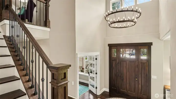 Statement chandelier and front door greet you.