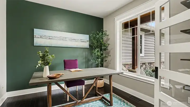 The main floor office features French doors and views of the front yard & porch.