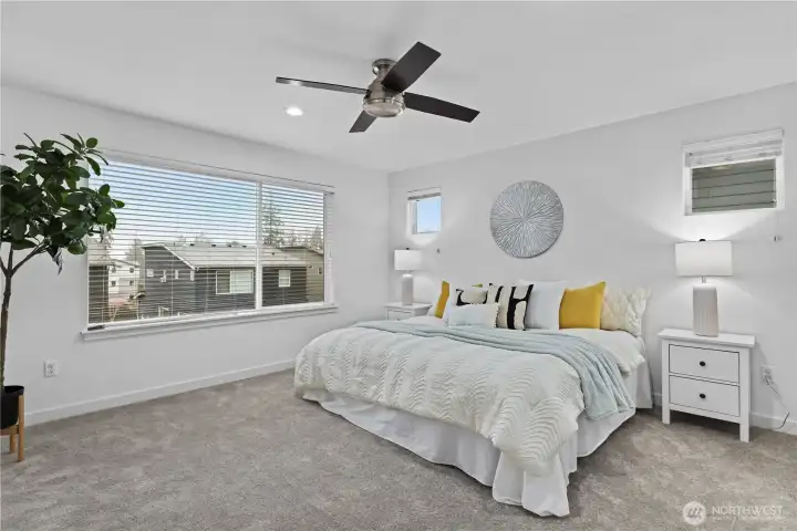 Large Primary bedroom with so much natural light. The spacious room offers a tranquil escape, flooded with sunlight throughout the day.