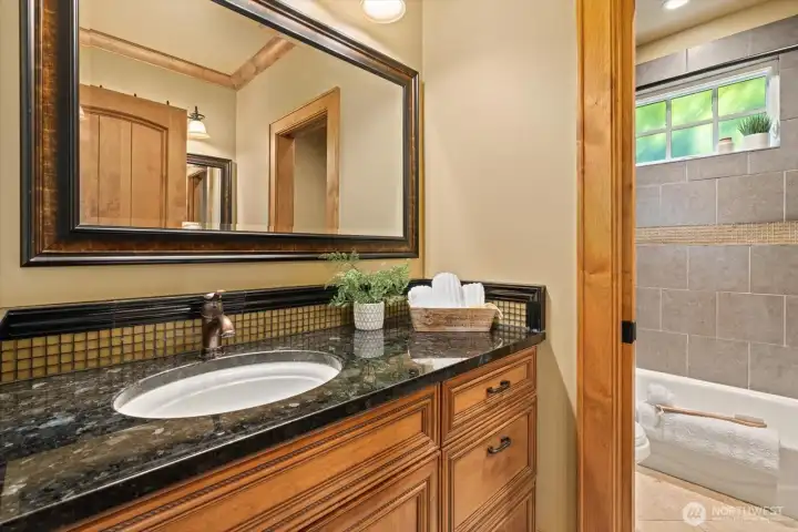 Full bath on main floor positioned between the 2 smaller bedrooms