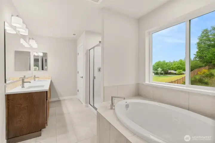 Primary bathroom- 5-piece. Soaking tub with tile surround, tile flooring and quartz countertops.