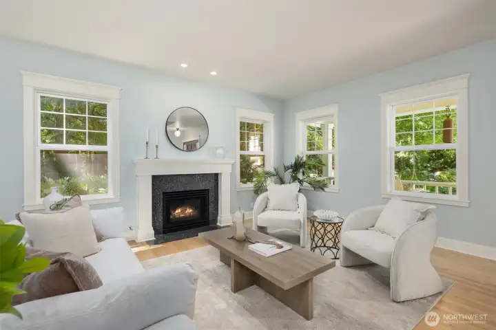 The formal living room with a cozy propane fireplace is just off of the entryway.