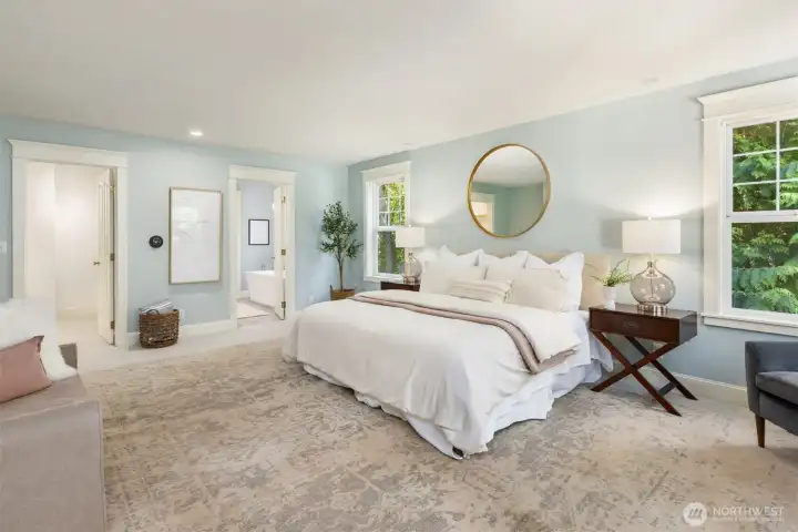The primary bedroom has ample room for a king bed and dressers plus a walk-in closet.