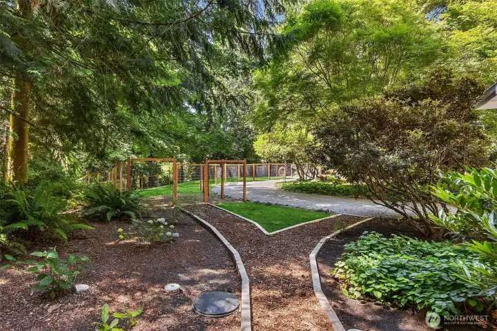 Paths surround the deck and home and lead to a large fenced grassy area on the property that also has an RV parking pad. Perfect for pets and play. There is also a shed on the property for additional dry storage.