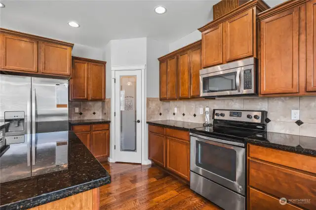 Kitchen with Pantry Closet & Tile Backsplash