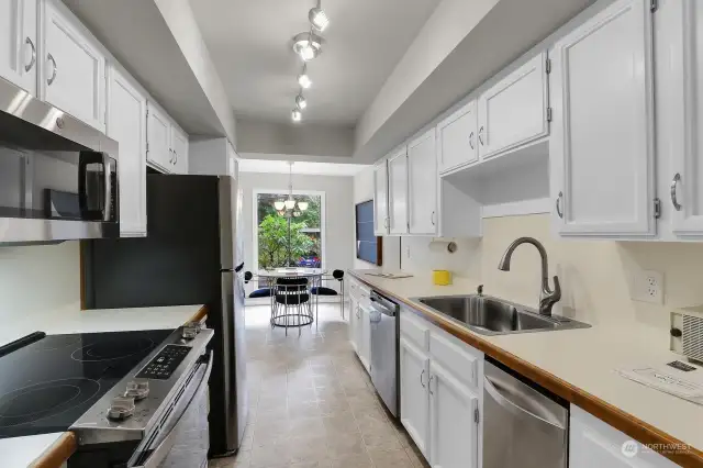 All new stainless steel appliances in this galley kitchen between both dining areas