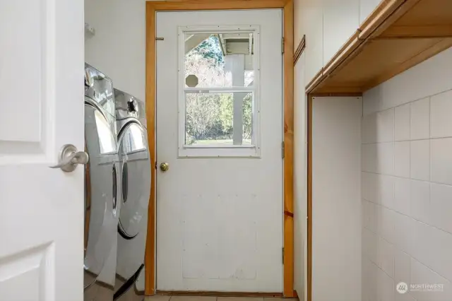 Laundry room downstairs with access to backyard.