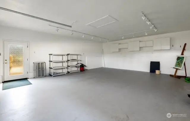 642 sq ft insulated shop with track lighting, cupboards, and large heater.