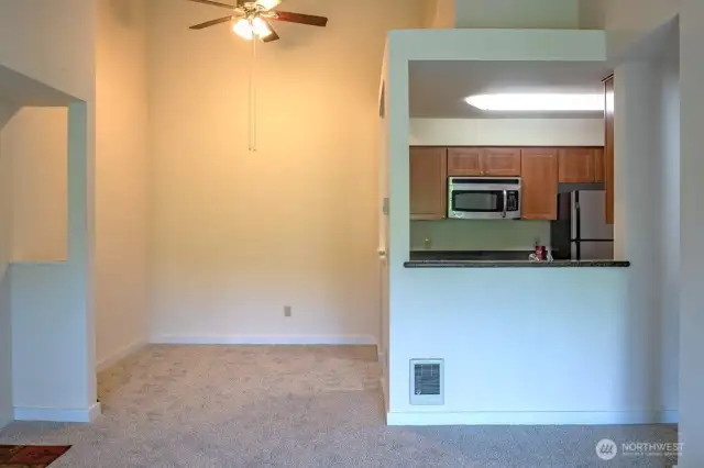 Dining room with ceiling fan.  There are some furnishings in the home still.