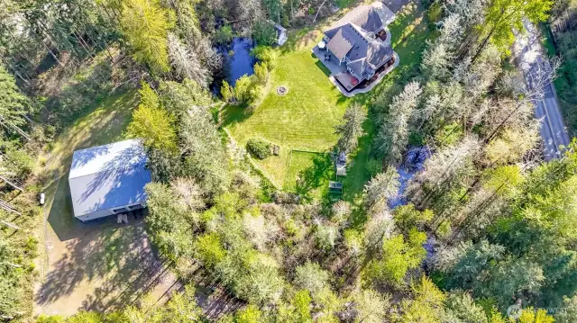This photo shows the 5,000sq ft garage on the east end of the property and the house to the west (and Christansen-Muck Rd)