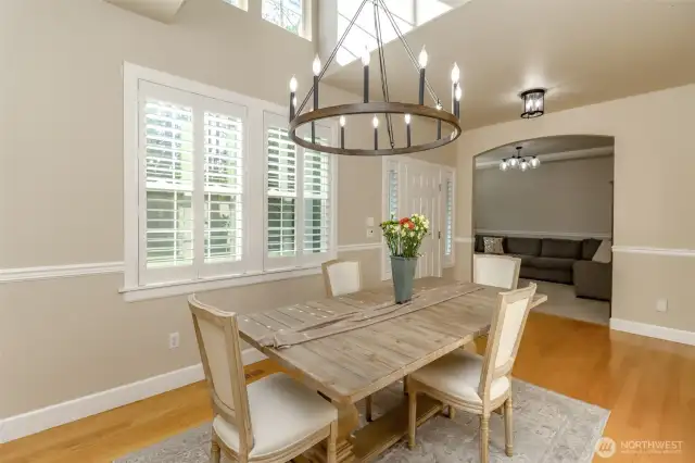 The dining room has plantation shutters and is adjacent to the foyer