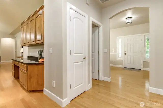 The main hall wraps around past the coat closet and winds to the kitchen